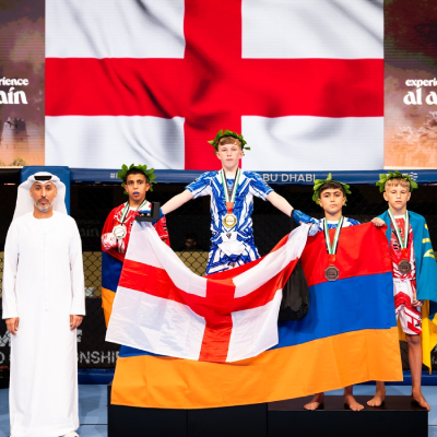 Mark Ghambaryan receives the silver medal on the podium during the IMMAF World Championship 2025 medal ceremony